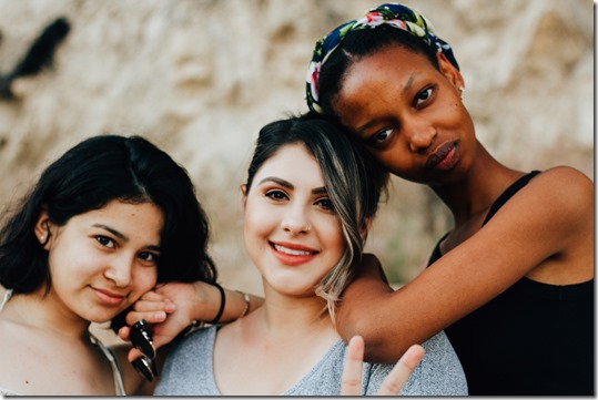 Three women friends and a peace sign